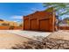 View of the three-car garage with a spacious driveway and a decorative spiral staircase on the right at 9137 E Odessa St, Mesa, AZ 85207