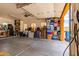 Garage interior with shelves for storage and an open overhead door at 9137 E Odessa St, Mesa, AZ 85207