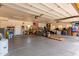 Spacious garage with ample storage space and an American flag hanging on the wall at 9137 E Odessa St, Mesa, AZ 85207