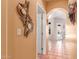 Hallway leading to pool area, featuring decorative mirror and tile flooring at 9137 E Odessa St, Mesa, AZ 85207