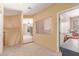 Hallway leading to a bedroom, showcasing neutral paint and carpet, with a view to the living area at 9137 E Odessa St, Mesa, AZ 85207