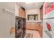 Convenient laundry area featuring wood cabinetry and a pair of sleek, front-load washer/dryer units at 9137 E Odessa St, Mesa, AZ 85207