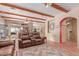 Spacious living room featuring leather furniture, terra cotta floors, and open floor plan at 9137 E Odessa St, Mesa, AZ 85207