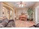 Cozy living room showcasing terra cotta flooring, piano, ship model, and comfortable seating at 9137 E Odessa St, Mesa, AZ 85207