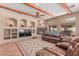 Spacious living room with wooden beam ceilings, fireplace, and built-in shelving at 9137 E Odessa St, Mesa, AZ 85207