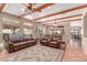 Open living room with exposed beam ceiling, terra cotta floors, and leather recliners at 9137 E Odessa St, Mesa, AZ 85207