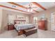 Main bedroom with wooden beams, ceiling fan, and an ensuite bathroom at 9137 E Odessa St, Mesa, AZ 85207