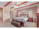 Comfortable main bedroom with wooden beams, ceiling fan, and access to ensuite bathroom at 9137 E Odessa St, Mesa, AZ 85207
