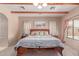 Relaxing main bedroom with a comfortable bed, wood beam ceiling, and cozy decor at 9137 E Odessa St, Mesa, AZ 85207