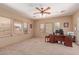 Spacious office featuring a ceiling fan, multiple windows, and a large desk area at 9137 E Odessa St, Mesa, AZ 85207