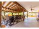 Spacious outdoor kitchen under covered patio with ceiling fans, seating, and bar, ideal for entertaining guests at 9137 E Odessa St, Mesa, AZ 85207