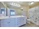 Bright bathroom featuring a double sink vanity, large mirror, and shower-tub combination at 920 E Devonshire Ave # 4021, Phoenix, AZ 85014