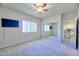 Bedroom with a large window, mirrored closet, and mounted television at 920 E Devonshire Ave # 4021, Phoenix, AZ 85014