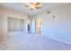 Large bedroom with a mirrored closet, ceiling fan, and a view into the kitchen at 920 E Devonshire Ave # 4021, Phoenix, AZ 85014