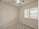 This is a cozy bedroom with a ceiling fan and window with plantation shutters at 920 E Devonshire Ave # 4021, Phoenix, AZ 85014