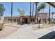 Exterior of the clubhouse with a sidewalk and palm trees surrounding the property at 920 E Devonshire Ave # 4021, Phoenix, AZ 85014