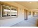 Exterior hallway featuring the door and window of unit 1021 with tan colored walls at 920 E Devonshire Ave # 4021, Phoenix, AZ 85014