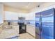 Well-lit kitchen features stainless steel appliances, granite countertops, and white cabinetry at 920 E Devonshire Ave # 4021, Phoenix, AZ 85014