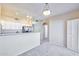 Open-concept living space with kitchen bar, modern lighting, and neutral decor at 920 E Devonshire Ave # 4021, Phoenix, AZ 85014