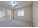 Comfortable living room with neutral carpeting, ceiling fan, and bright window at 920 E Devonshire Ave # 4021, Phoenix, AZ 85014