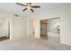 Neutral bedroom with carpet, en suite access to bathroom, closet and a ceiling fan at 9705 E Mountain View Rd # 1050, Scottsdale, AZ 85258