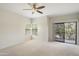 Bright bedroom with a ceiling fan, large windows, and sliding door to the outside balcony at 9705 E Mountain View Rd # 1050, Scottsdale, AZ 85258
