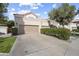 Inviting exterior view of home, featuring a two-car garage, well-maintained landscaping, and a cozy entrance at 9705 E Mountain View Rd # 1050, Scottsdale, AZ 85258