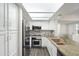 Modern kitchen with stainless appliances, white cabinets, granite countertops, and backsplash at 9705 E Mountain View Rd # 1050, Scottsdale, AZ 85258