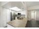 Kitchen featuring white cabinets, stainless steel appliances, granite counters, and modern lighting at 9705 E Mountain View Rd # 1050, Scottsdale, AZ 85258