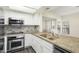 Well-equipped kitchen featuring stainless steel appliances, granite countertops, and ample cabinet space at 9705 E Mountain View Rd # 1050, Scottsdale, AZ 85258