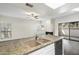 Open-concept kitchen features a granite island with sink, stainless steel appliances, and fireplace at 9705 E Mountain View Rd # 1050, Scottsdale, AZ 85258