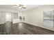 Spacious living room with wood-look floors, ceiling fan, and abundant natural light from large windows at 9705 E Mountain View Rd # 1050, Scottsdale, AZ 85258