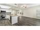 Bright living room seamlessly connects with the kitchen, showcasing wood-look floors and updated appliances at 9705 E Mountain View Rd # 1050, Scottsdale, AZ 85258