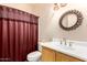 Bathroom featuring a decorative mirror, vanity sink, toilet, and burgundy shower curtain at 9750 N Monterey Dr # 21, Fountain Hills, AZ 85268