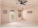 Bright bedroom with neutral carpet, a ceiling fan, and a private door to an outdoor patio at 9750 N Monterey Dr # 21, Fountain Hills, AZ 85268
