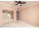 Neutral carpeted bedroom with ceiling fan, mirrored closet doors, and patio access at 9750 N Monterey Dr # 21, Fountain Hills, AZ 85268