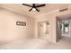 Carpeted bedroom features a ceiling fan, mirrored closet doors, and hall access at 9750 N Monterey Dr # 21, Fountain Hills, AZ 85268