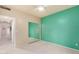 Bedroom with neutral carpet, mirrored closet, teal accent wall, and hall access at 9750 N Monterey Dr # 21, Fountain Hills, AZ 85268