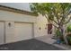 Inviting condo exterior featuring a private garage, entry staircase, and mature desert landscaping at 9750 N Monterey Dr # 21, Fountain Hills, AZ 85268