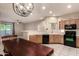 Well-lit kitchen showcasing black appliances, tile floors, and pass through to living area at 9750 N Monterey Dr # 21, Fountain Hills, AZ 85268
