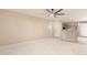 Neutral living space featuring a ceiling fan, window, tile floors, and pass through to the kitchen at 9750 N Monterey Dr # 21, Fountain Hills, AZ 85268