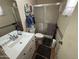 Bathroom with a walk-in shower featuring a glass door and accessible grab bars at 10833 N 43Rd Dr, Glendale, AZ 85304
