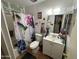 Bright bathroom featuring a shower/tub combo with floral curtains, and a vanity with a sink and storage at 10833 N 43Rd Dr, Glendale, AZ 85304