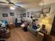 Cozy living room with a ceiling fan, wood flooring, and decorated with lots of personal touches at 10833 N 43Rd Dr, Glendale, AZ 85304