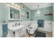Elegant bathroom with a clawfoot tub, pedestal sink, and decorative chandelier lighting at 11021 N 64Th Ln, Glendale, AZ 85304