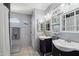 Comfortable bathroom featuring double sinks, modern fixtures and tiled floors at 11021 N 64Th Ln, Glendale, AZ 85304