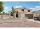 Inviting two-story home featuring a well-maintained lawn, desert landscape, and an attached two-car garage at 11021 N 64Th Ln, Glendale, AZ 85304