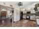 Well-lit kitchen boasts modern appliances, granite countertops, a pantry, and wood-look flooring at 11021 N 64Th Ln, Glendale, AZ 85304