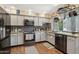 Stylish kitchen with stainless steel appliances, granite countertops, and decorative backsplash at 11021 N 64Th Ln, Glendale, AZ 85304