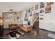 Comfortable living area with hardwood floors, tan leather couches, and movie-themed wall art at 11021 N 64Th Ln, Glendale, AZ 85304